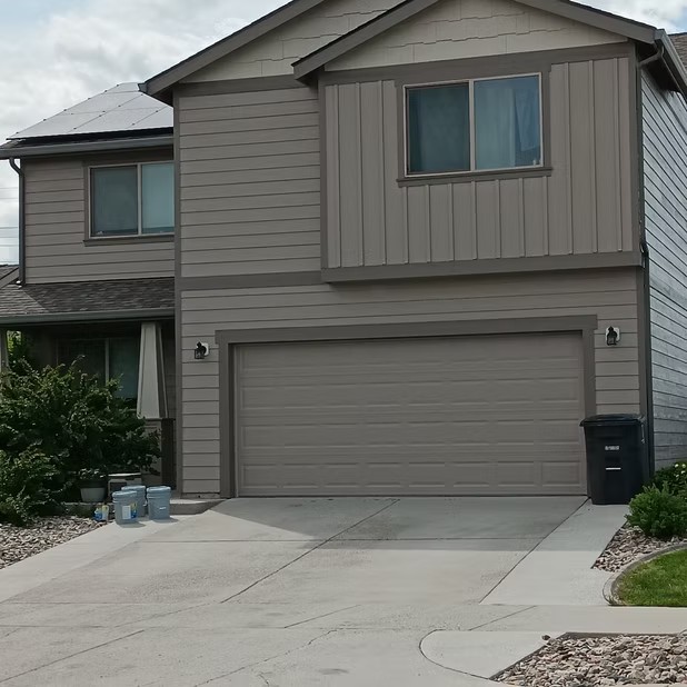 Taupe two-story home and garage
