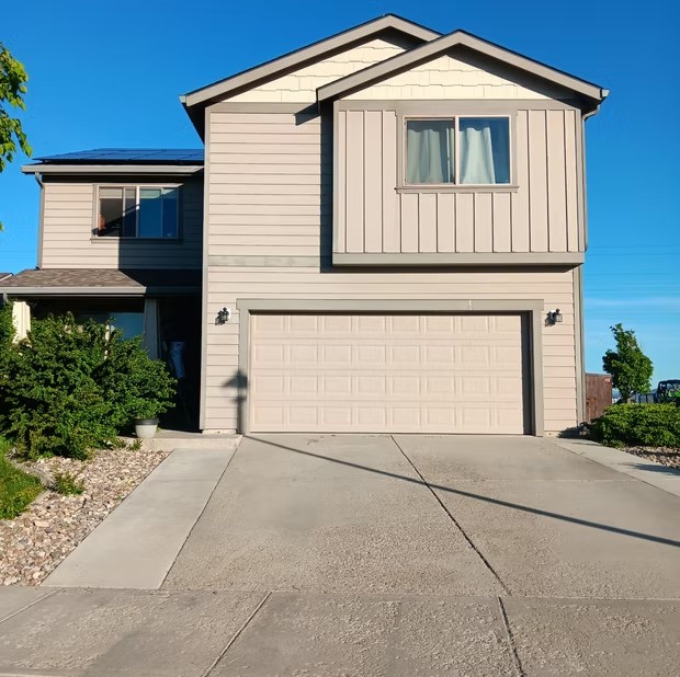 Tan home with attached garage
