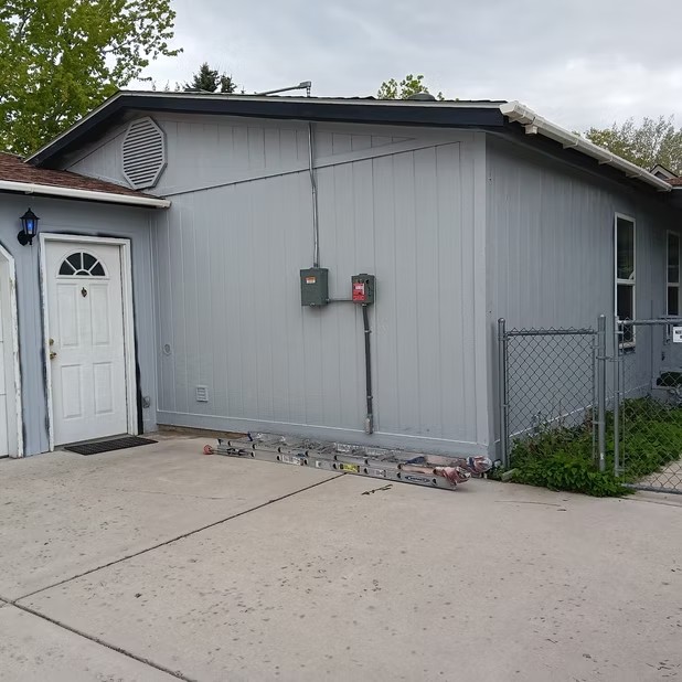 Gray siding and a white entry door