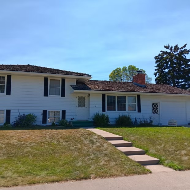 White ranch house and green lawn