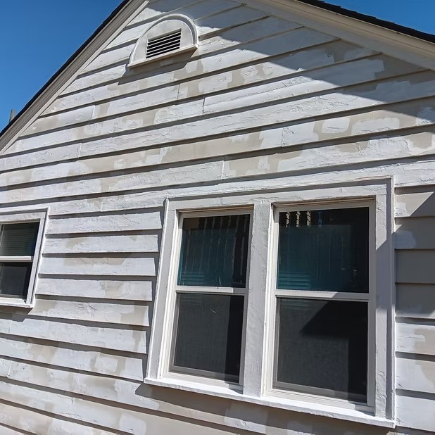 White siding and trimmed windows